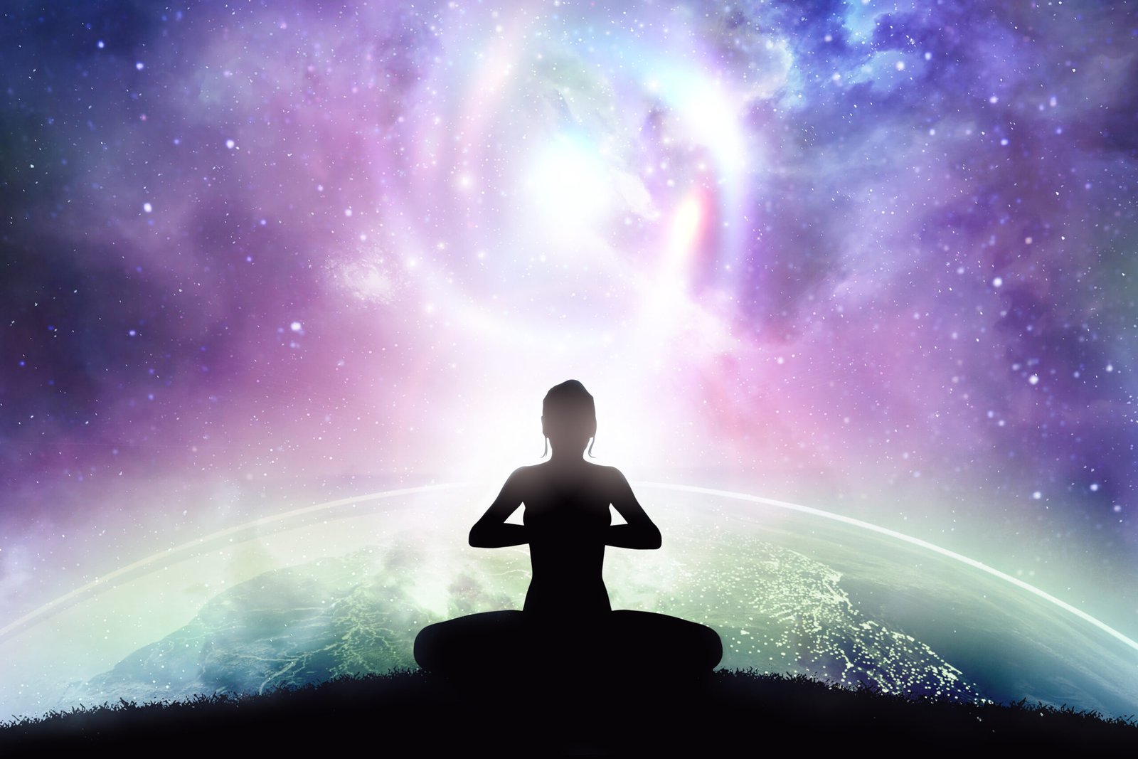 Person meditating under a starry cosmic sky